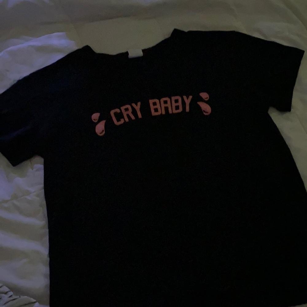 A black “Cry Baby” crop top.